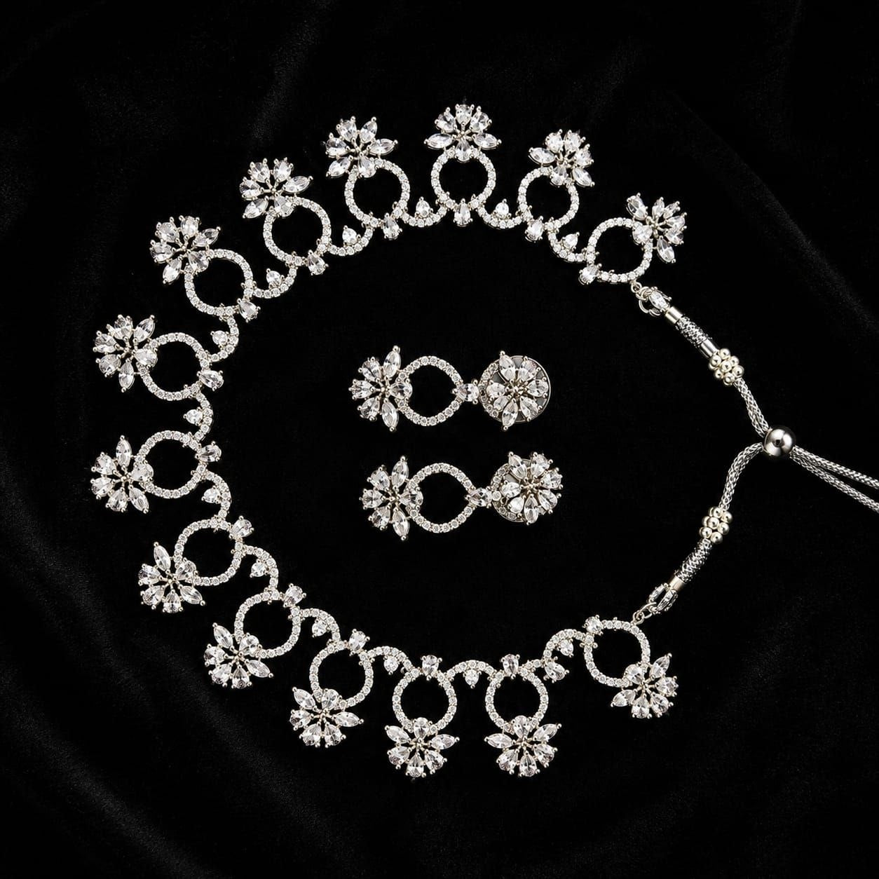 Premium silver floral necklace with crystal accents and matching earrings displayed on black bust 3