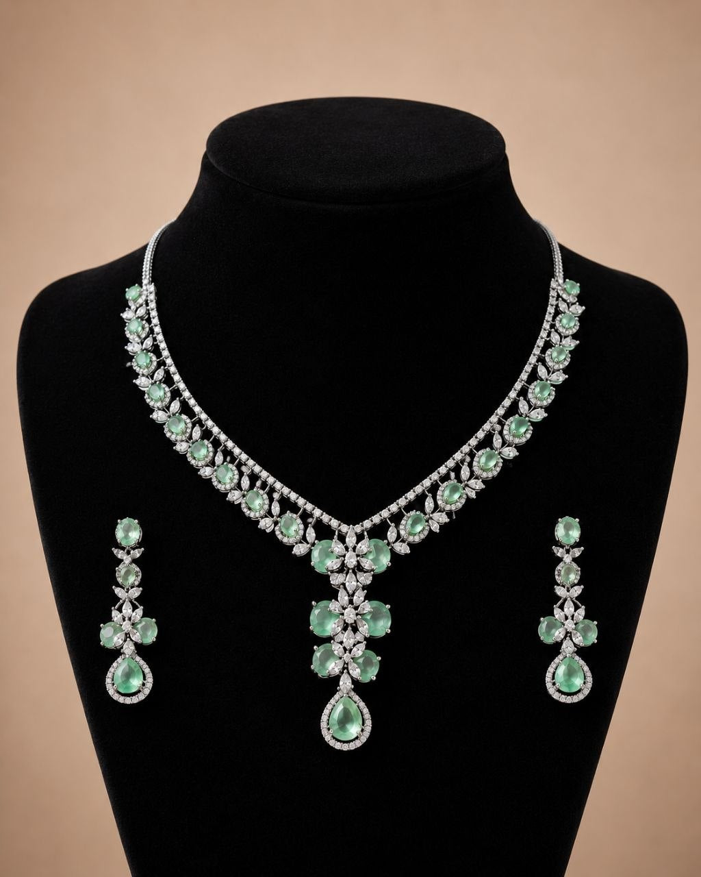 Mint green floral gemstone necklace with matching drop earrings set featuring clear stones on beige display bust 3