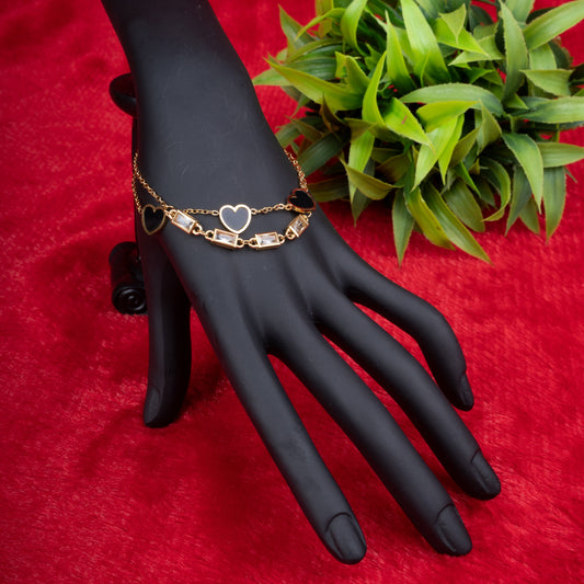 Gold-tone dual layer bracelet with black heart charms and rectangular crystal accents - Revaaj