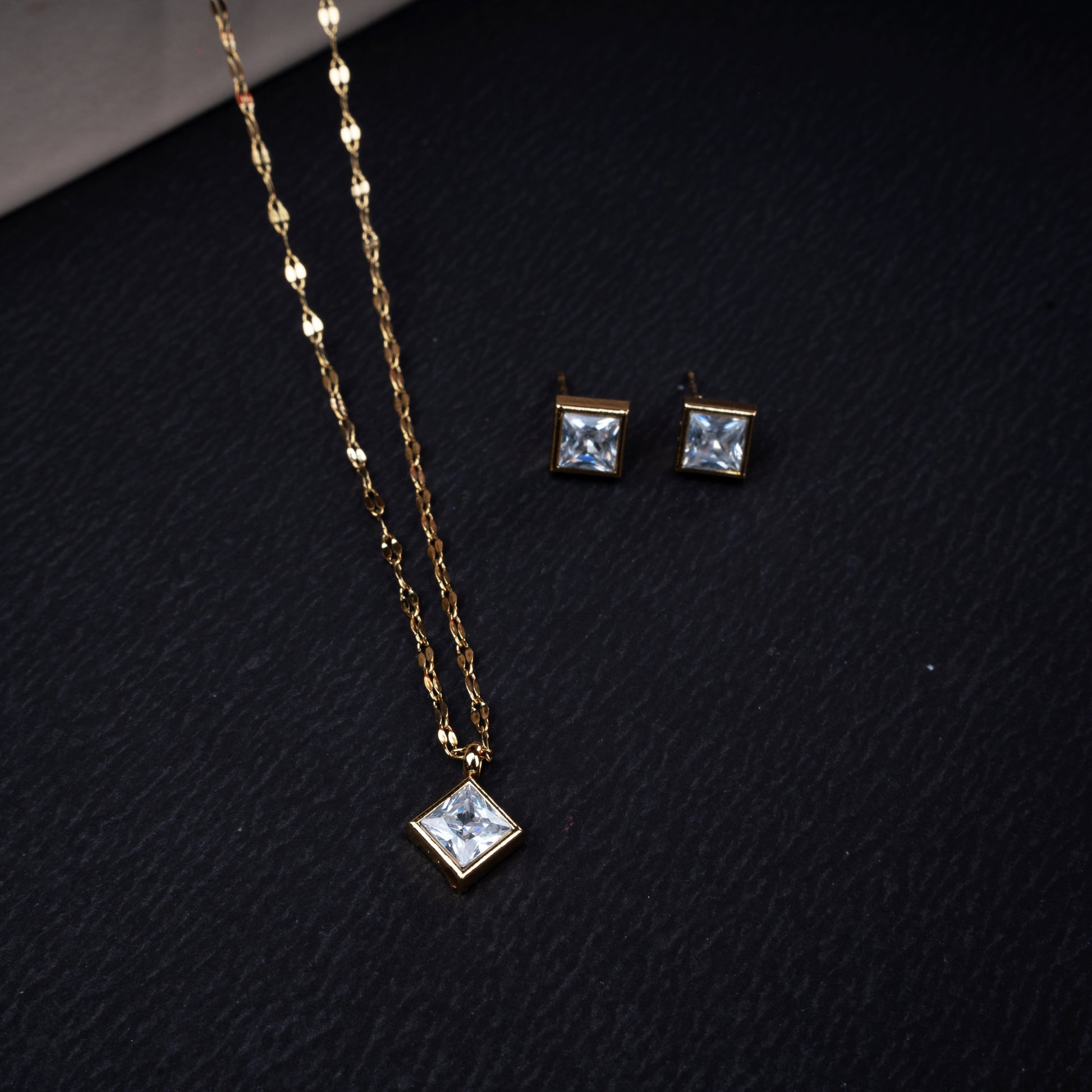 Golden square crystal necklace with matching earrings in gold-tone finish - Revaaj