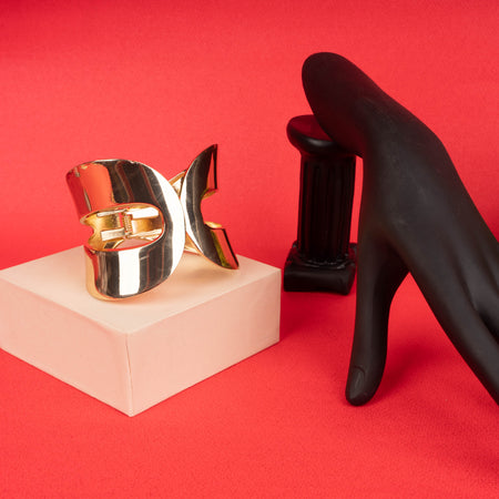 Bold gold statement cuff bracelet with abstract sculptural design - Revaaj