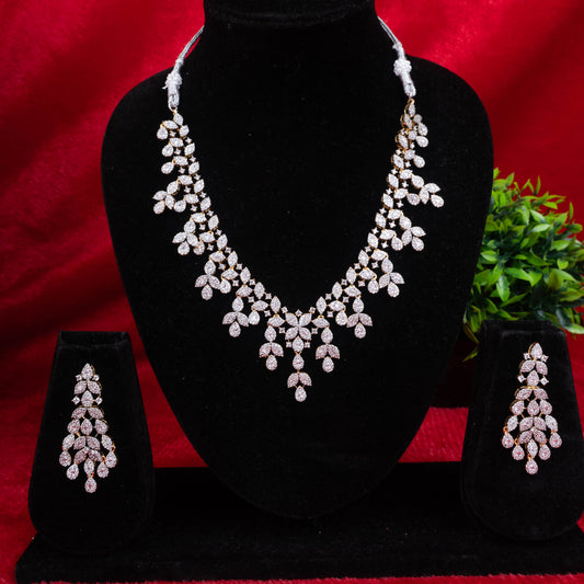Silver-tone cascading leaf drop necklace and earrings set with synthetic stones on a black display - Revaaj