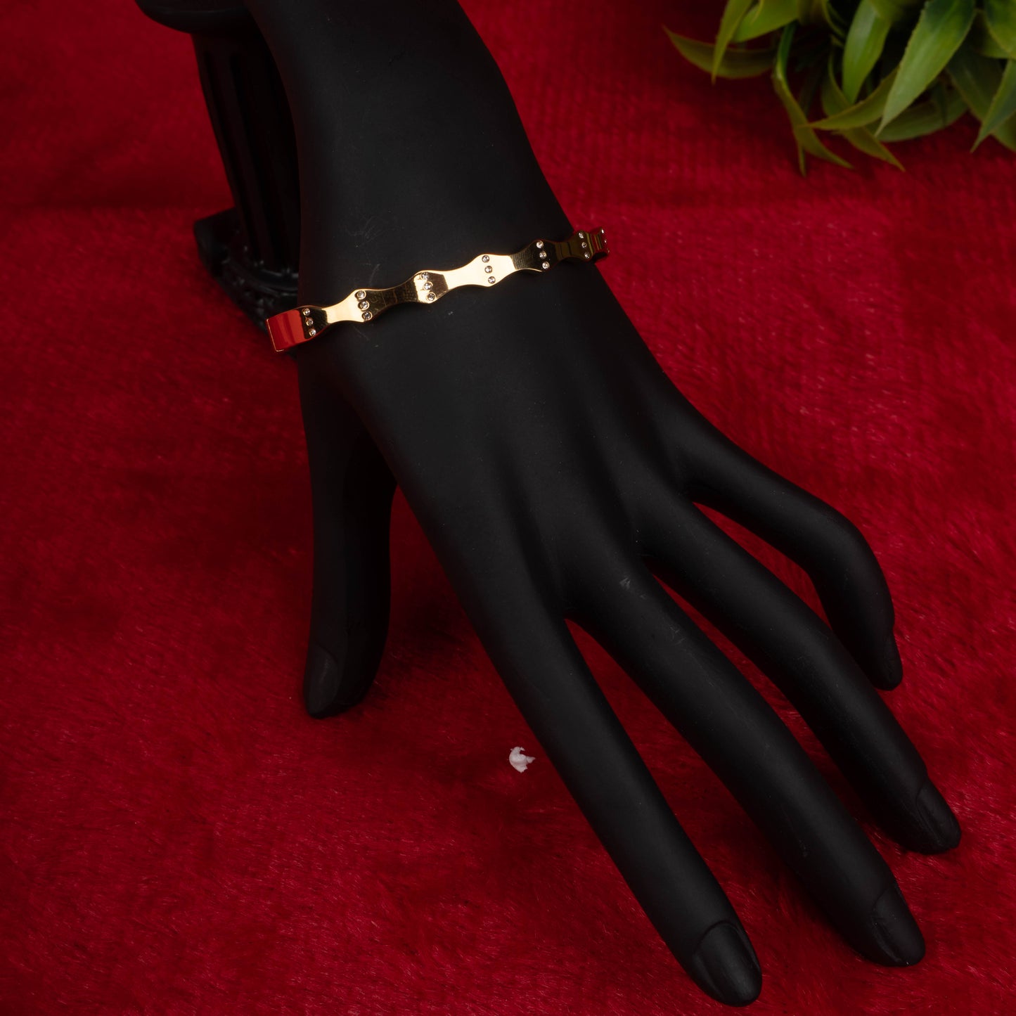 Gold-tone fashion bracelet with industrial link design on black mannequin hand - Revaaj Ground