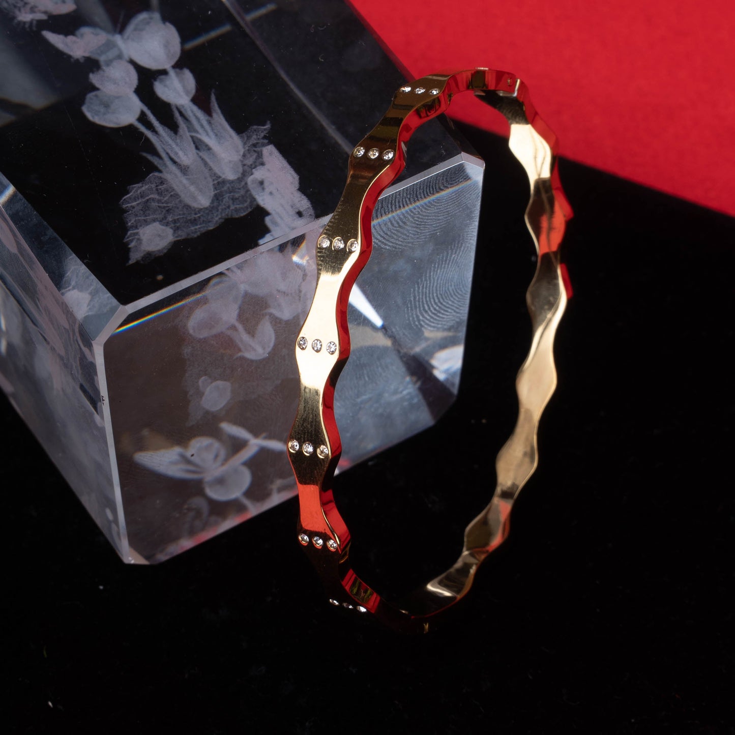 Gold-tone fashion bracelet with industrial link design on black mannequin hand - Revaaj Ground