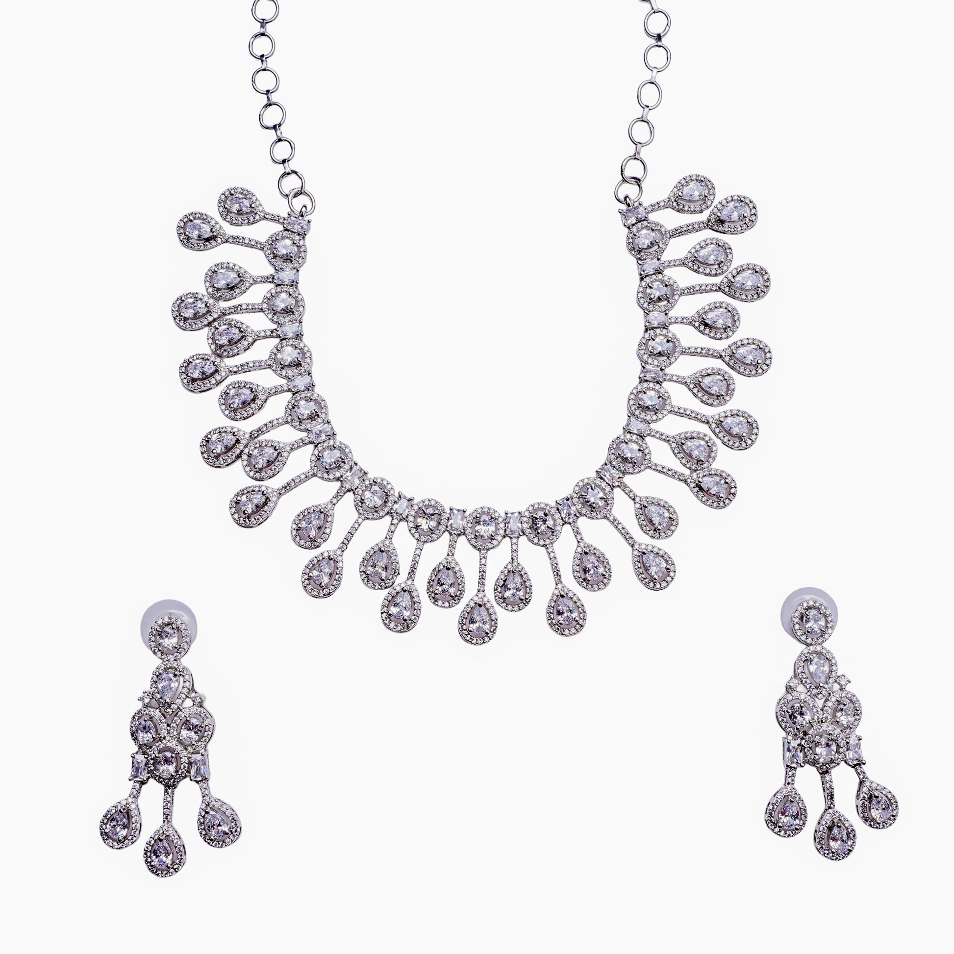 Silver necklace and earring set with teardrop diamond accents on white background