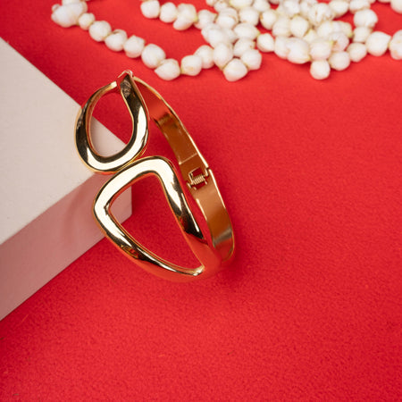 Gold abstract open shape bracelet with asymmetric cut-out design - Revaaj