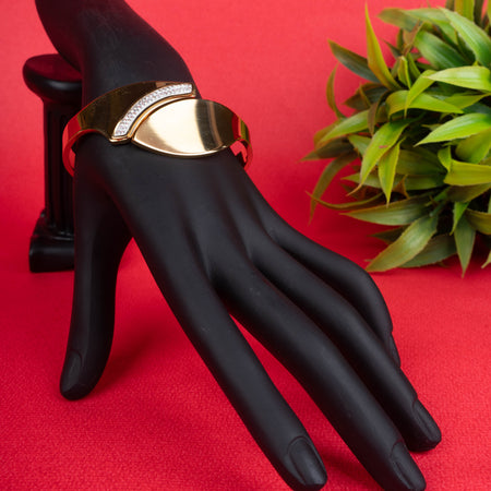 Gold-tone asymmetrical cuff bracelet with a row of sparkling crystals - Revaaj