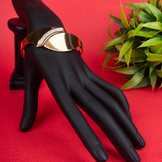 Gold-tone asymmetrical cuff bracelet with a row of sparkling crystals - Revaaj