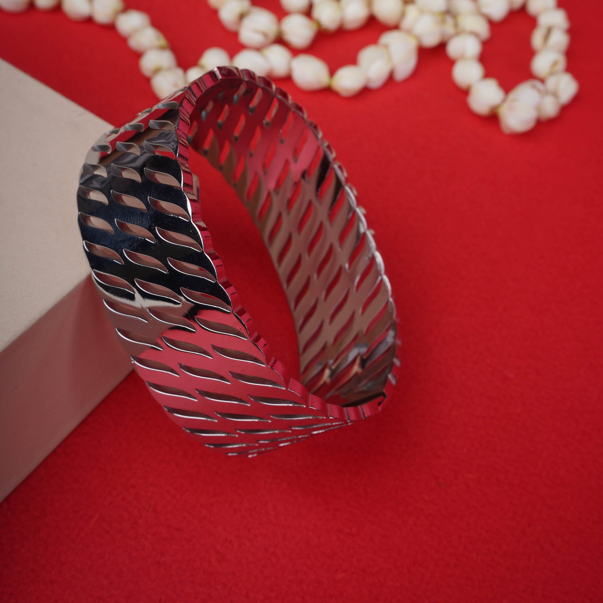 Wide, silver-tone open bracelet with an abstract geometric textured pattern ground image - Revaaj