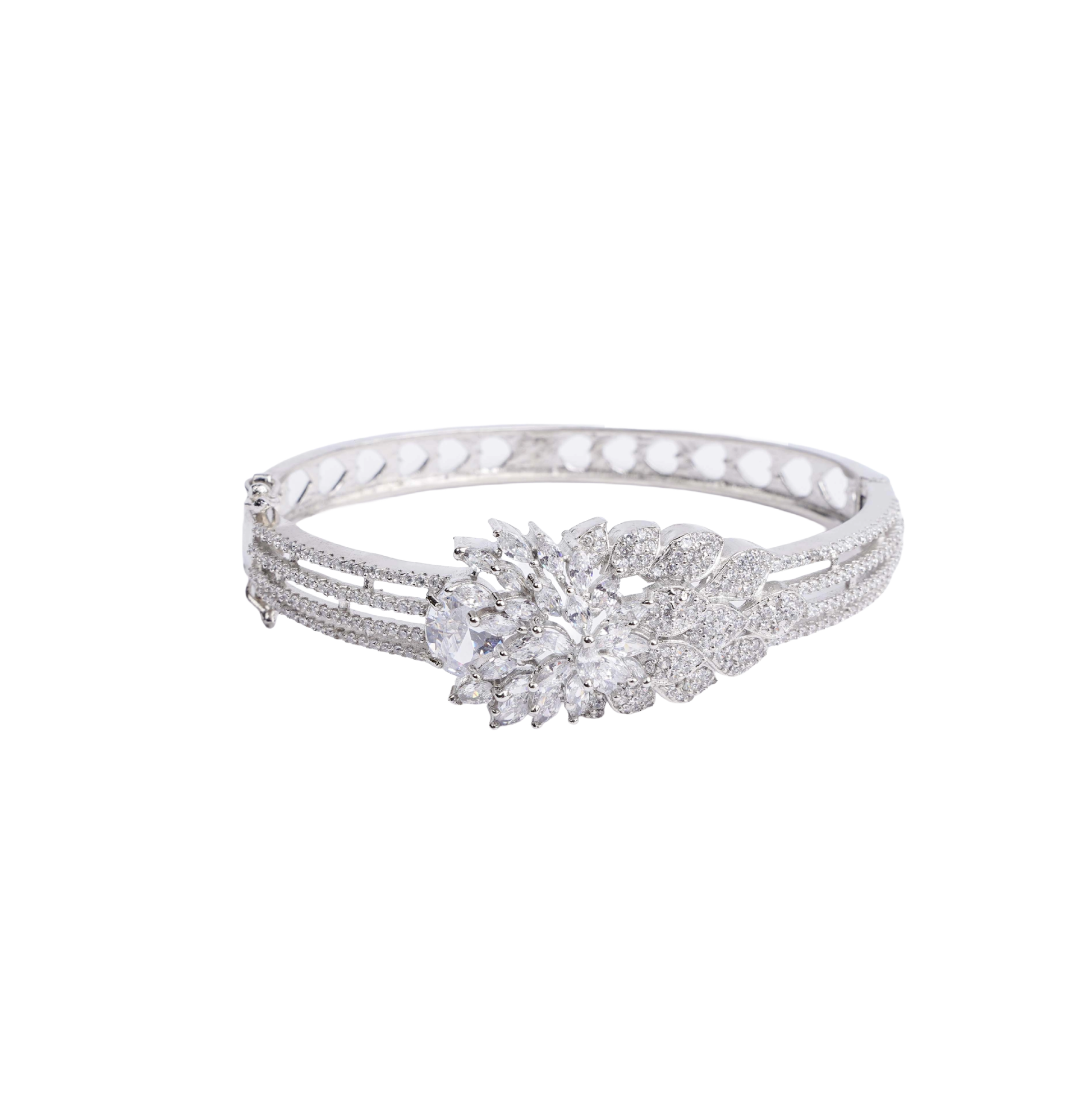Ornate silver-tone hinged bracelet with a large, sparkling floral cluster made of clear crystals, and a band decorated with three rows of crystals and heart-shaped cutouts white image - Revaaj
