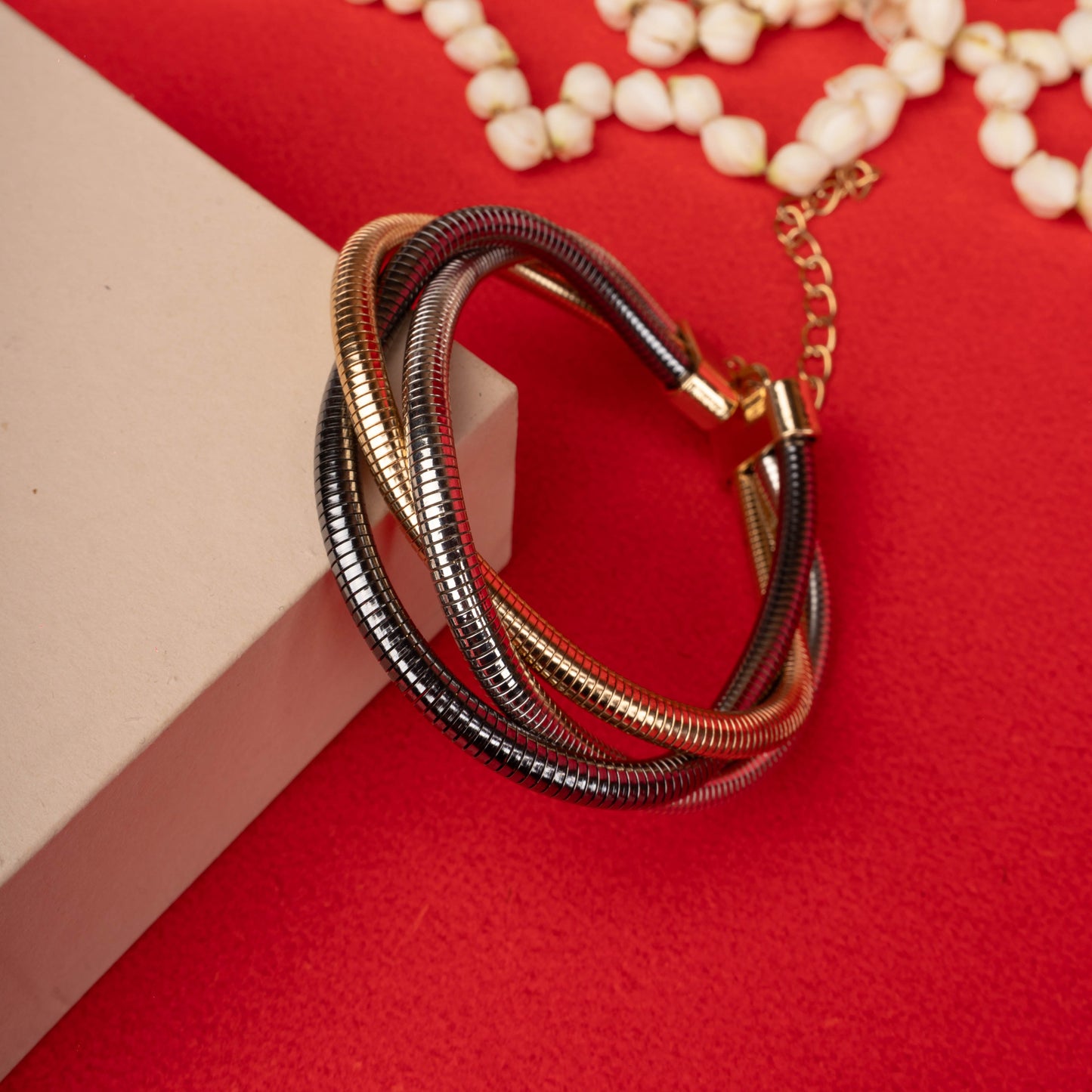 Multi-tone (silver and gold) intertwined snake chain bracelet with a gold-tone magnetic clasp ground image - Revaaj