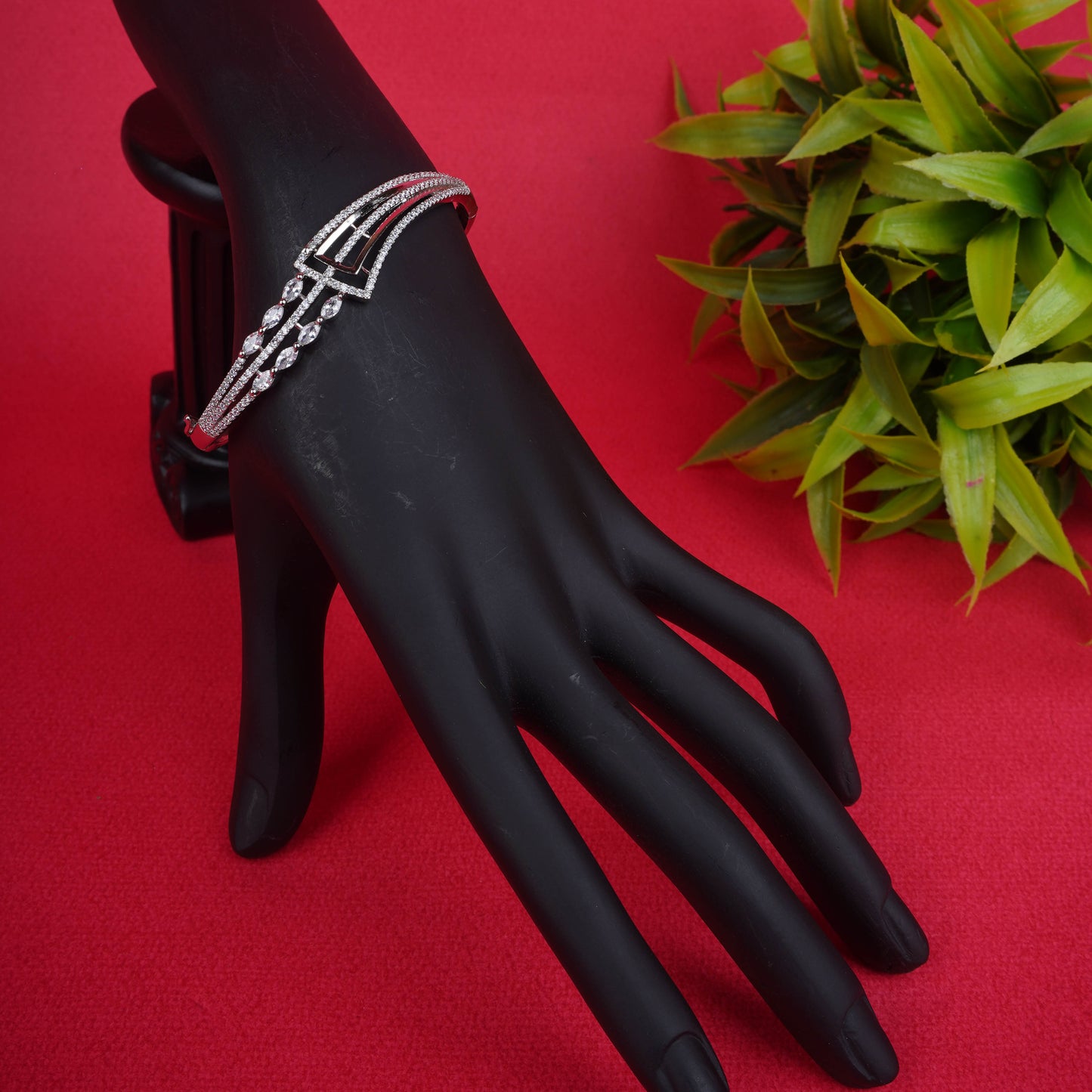 Silver-tone hinged bracelet with a sparkling geometric design, featuring pave crystals and marquise-cut crystal accents - Revaaj
