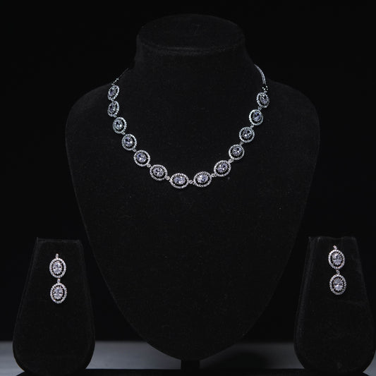 Elegant oval zirconia necklace set with matching drop earrings displayed on black stand