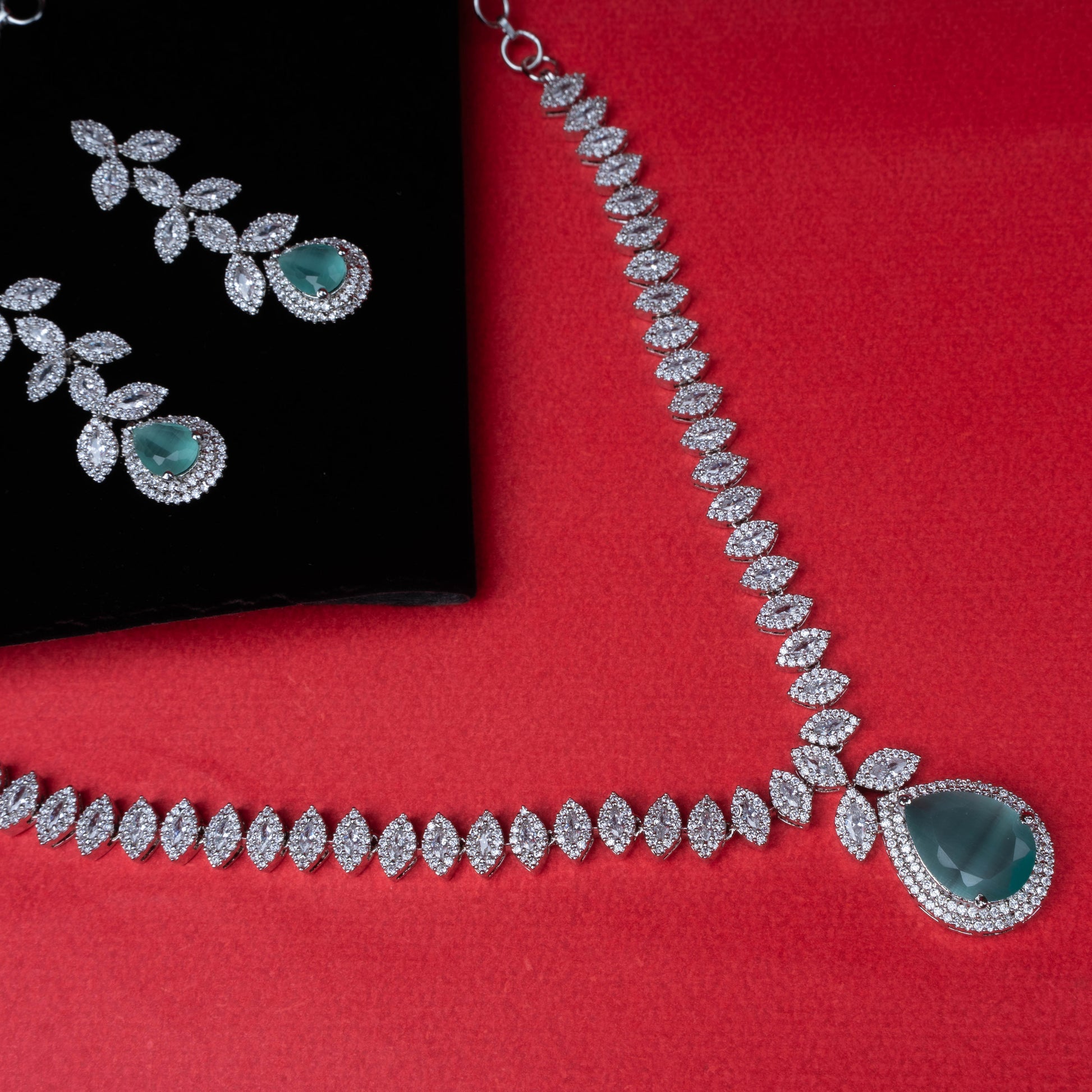 Emerald leaf elegance necklace set with green teardrop pendant and matching earrings second view - Revaaj