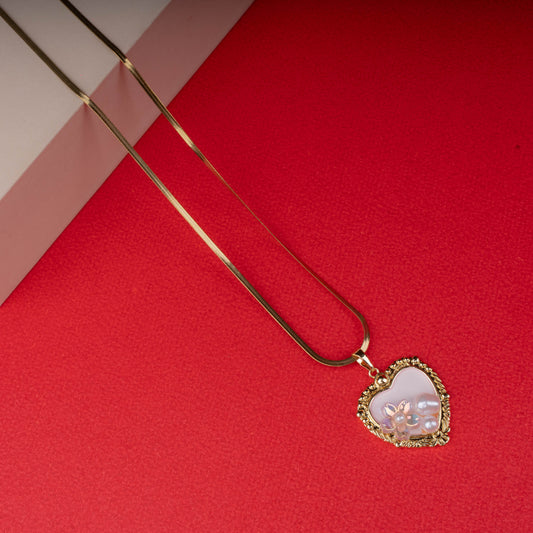 Gold necklace with textured chain and pink enamel pendant featuring a gold butterfly - Revaaj