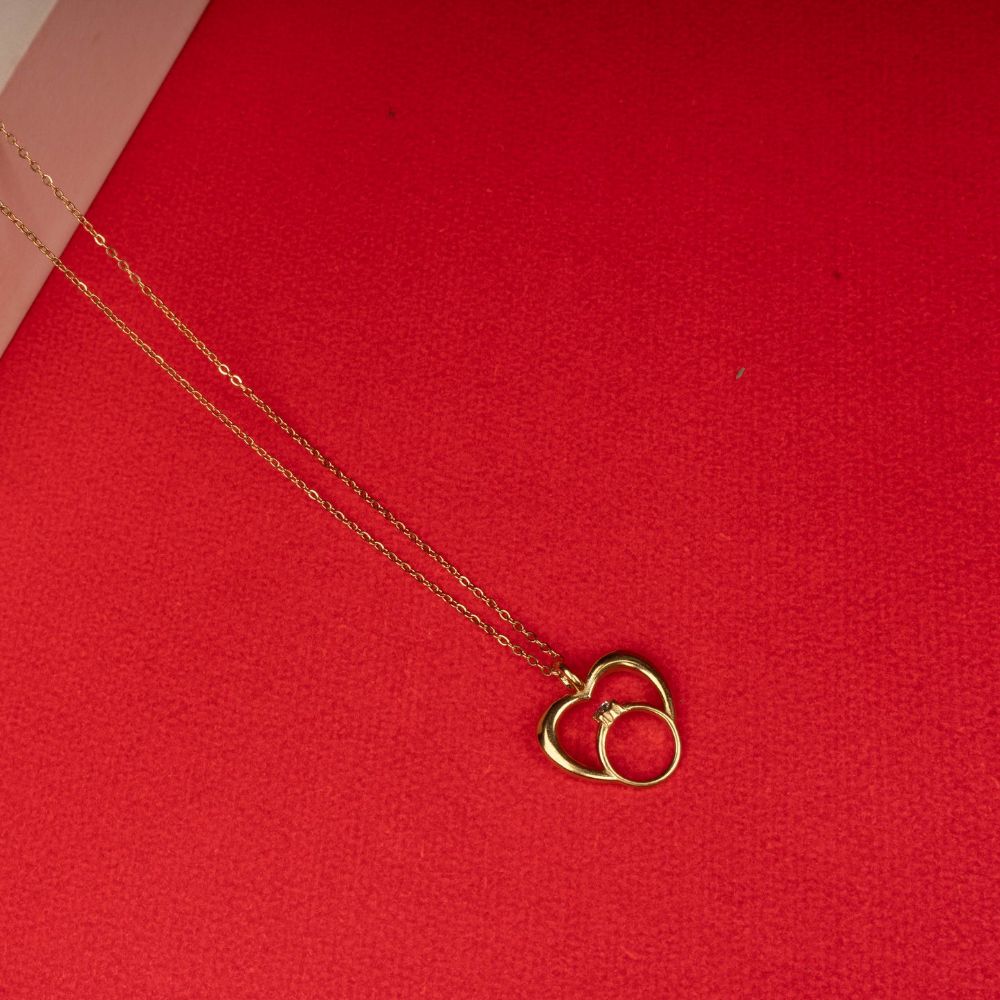 Gold heart pendant necklace with intertwined ring charm - Revaaj