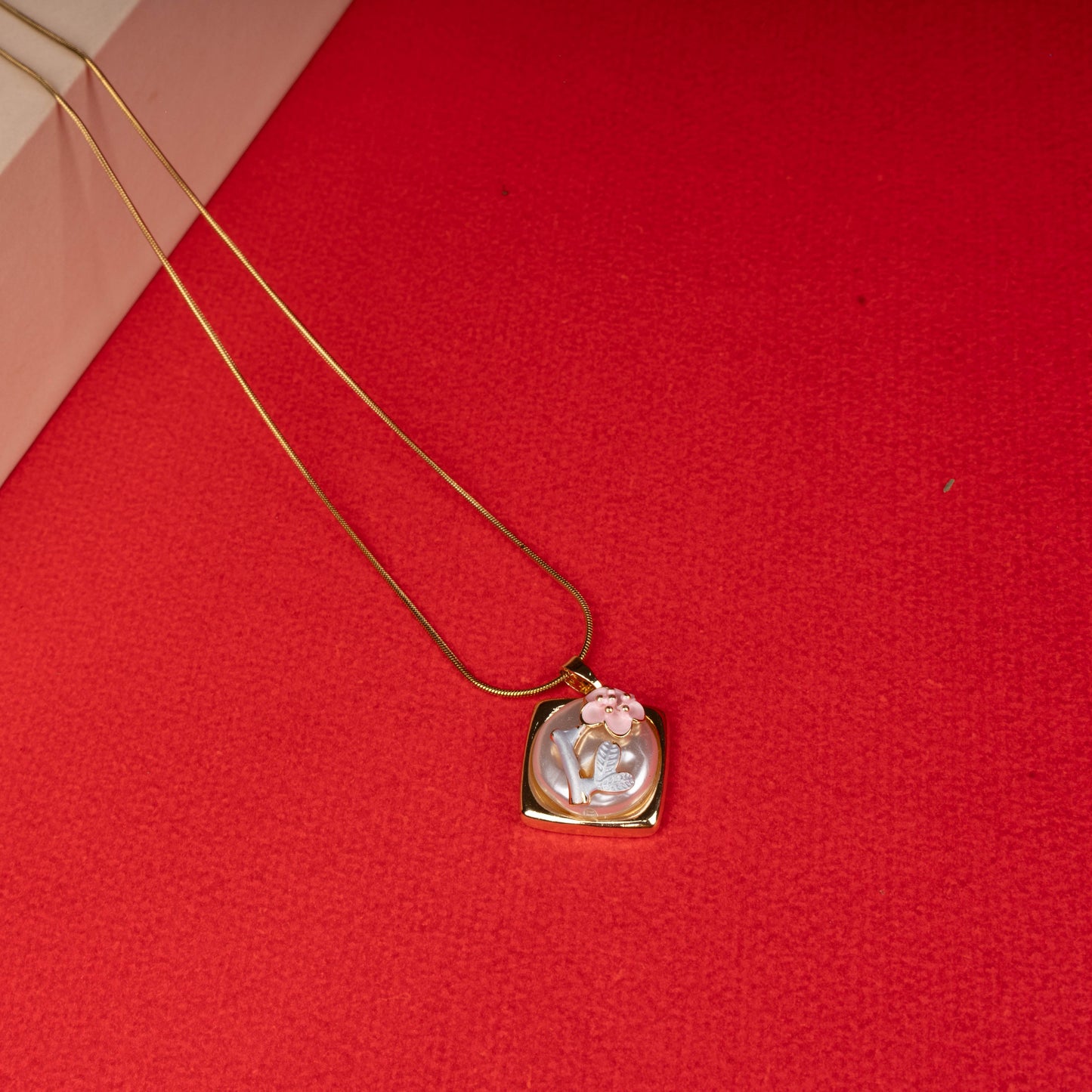 Gold floral mother-of-pearl pendant necklace with pink flower design floored image - Revaaj