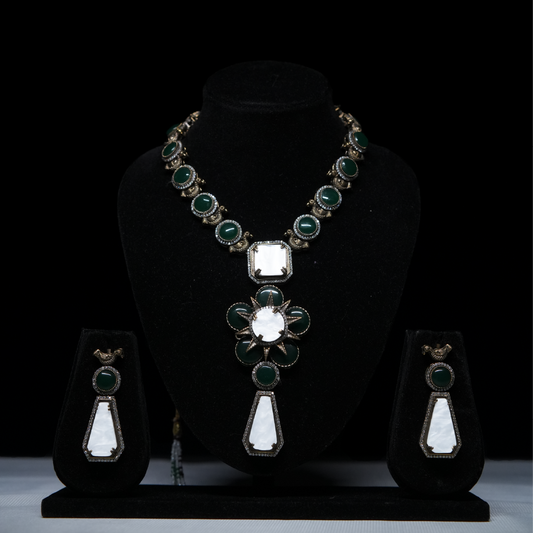 Revaaj Green and White Kundan Necklace Set displayed on a black stand, showcasing the necklace and matching earrings.