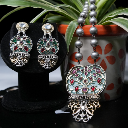 Revaaj Kundan necklace set with matching earrings featuring a teal and ruby design.