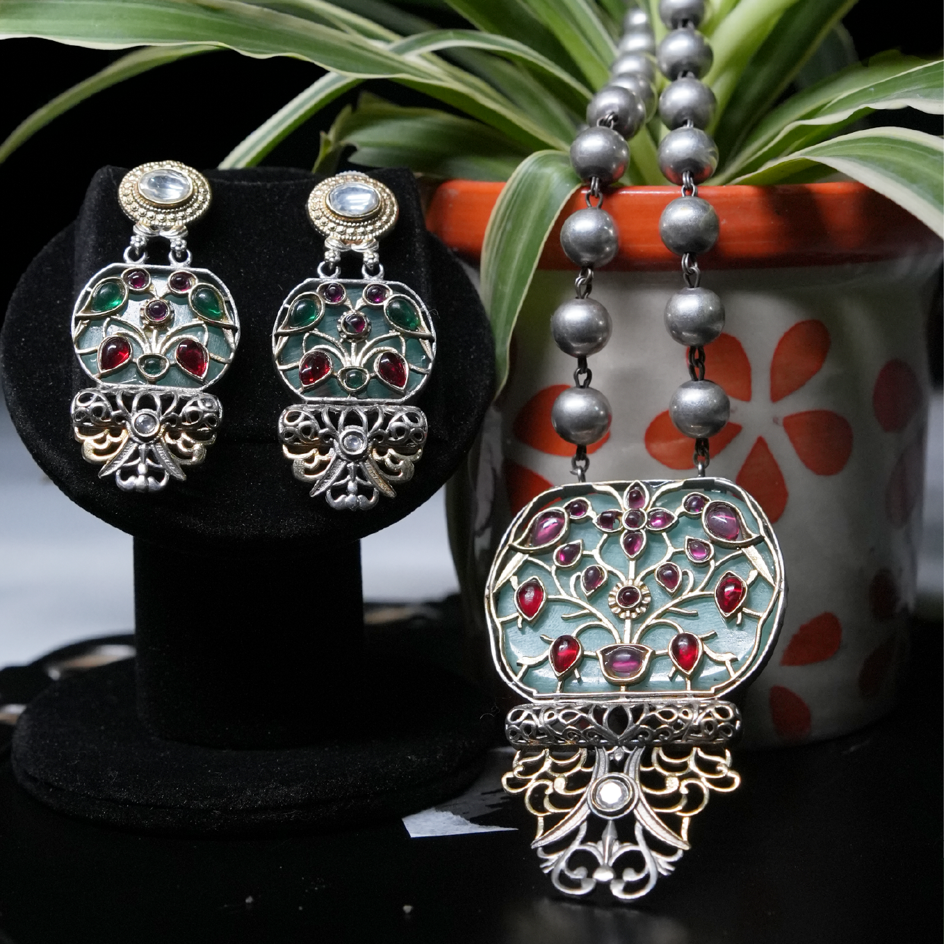 Revaaj Kundan necklace set with matching earrings featuring a teal and ruby design.