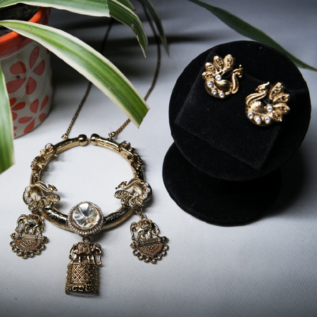 Revaaj Kundan necklace and earring set, featuring gold-toned metal, kundan stones, pearls, peacock and elephant designs.