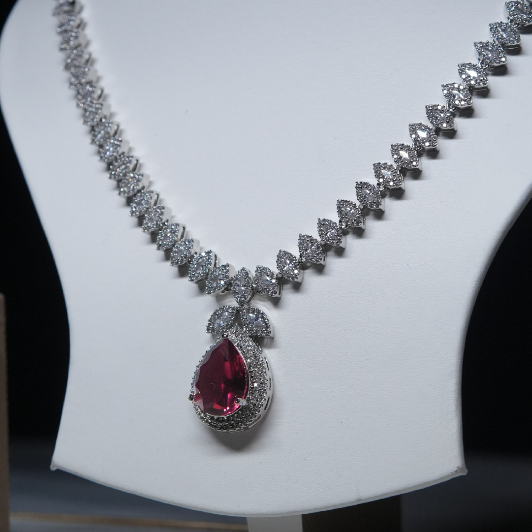 Revaaj Ruby and Diamond Necklace and Earring Set displayed on a white mannequin.