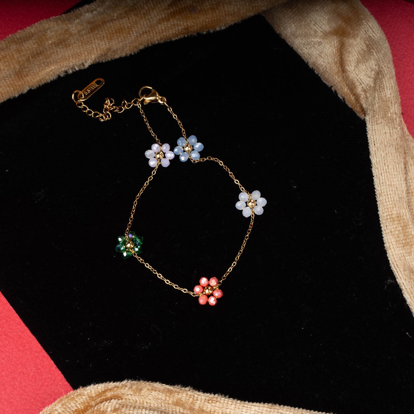 Multicolor floral charm bracelet with pastel and vibrant flowers accented by crystal centers second view - Revaaj