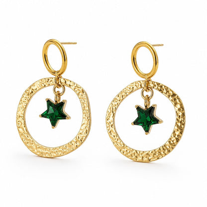 Pair of gold hammered circular hoop earrings with dangling green star crystal pendants on white background 1