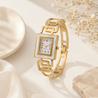 Gold square face women's watch with white mother of pearl dial and geometric link bracelet displayed on white background 3