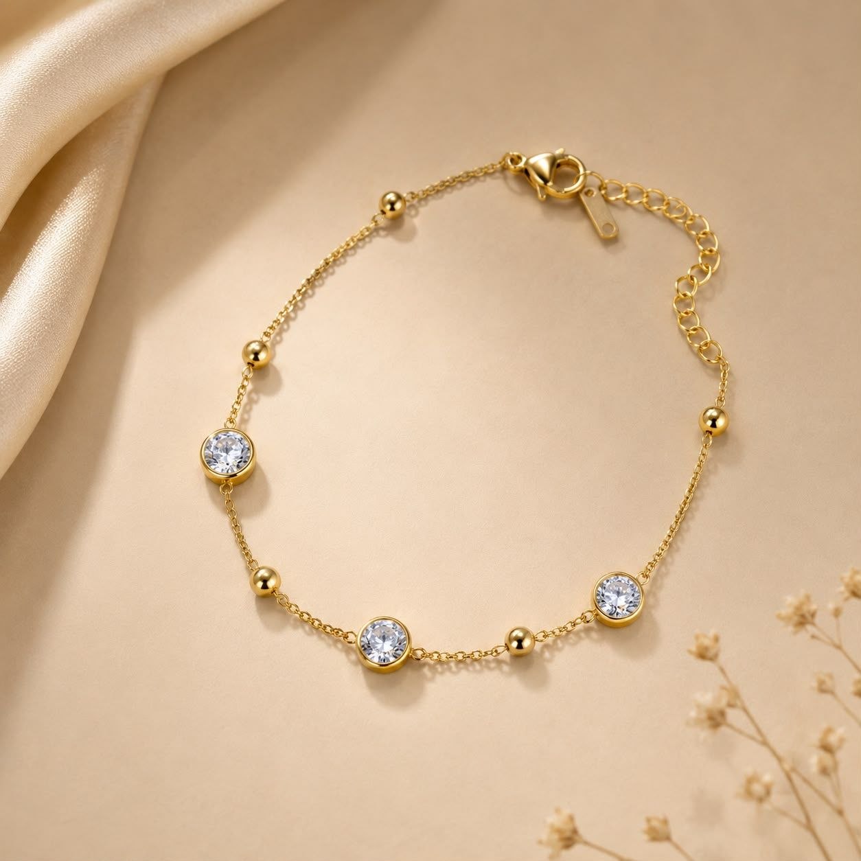 Delicate 18K gold plated chain bracelet with three round clear cubic zirconia stones and small gold beads on white background 3