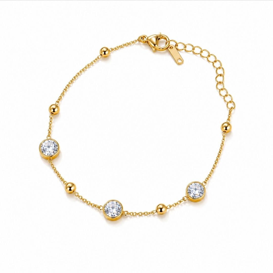 Delicate 18K gold plated chain bracelet with three round clear cubic zirconia stones and small gold beads on white background 1