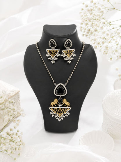 Royal black and gold Indian necklace set with lion motifs, large black stone pendant, pearl details and matching drop earrings on black display bust 1