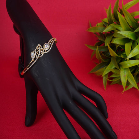 Gold floral stone-studded bracelet on display hand - Revaaj