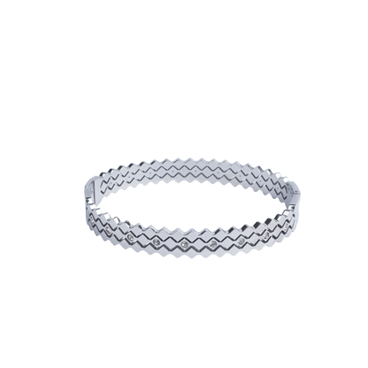 Silver zigzag bangle with embedded white stones on red background - Revaaj Ground