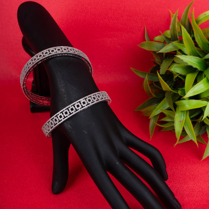 Silver geometric cut bangles with crystal detailing on red background - Revaaj Ground