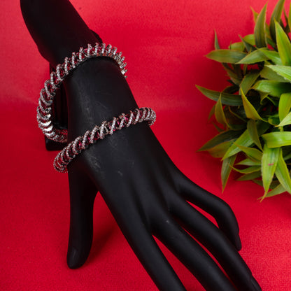 Silver looped crystal bangles with twisted stone design on red background - Revaaj Ground
