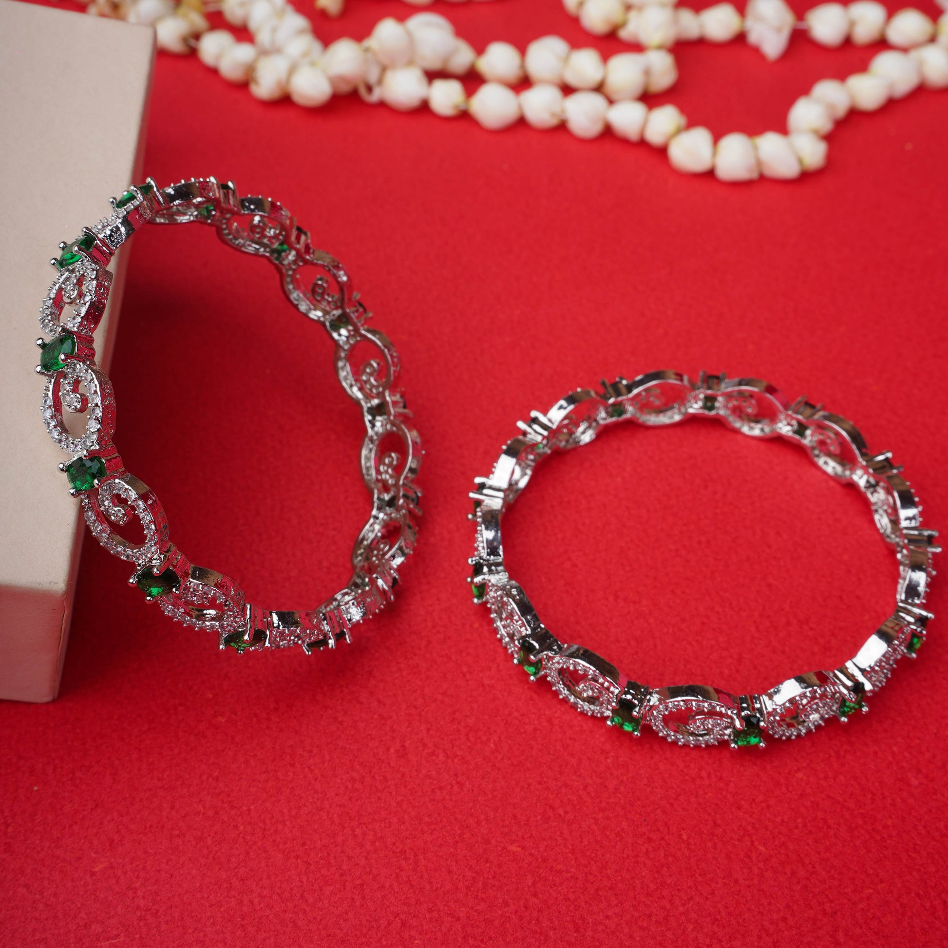 Silver bangles with white and green stones in loop pattern - Revaaj