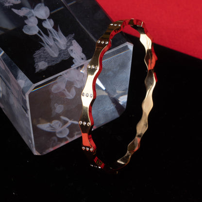 Gold-tone fashion bracelet with industrial link design on black mannequin hand - Revaaj Ground