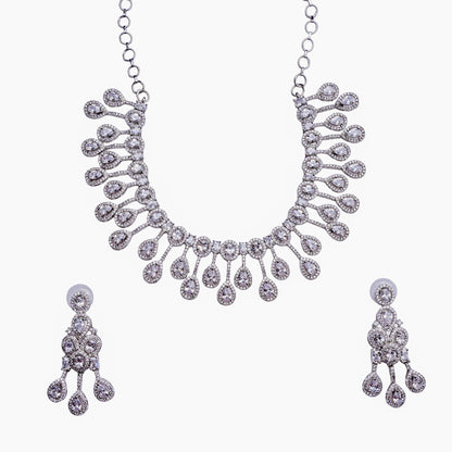 Silver necklace and earring set with teardrop diamond accents on white background