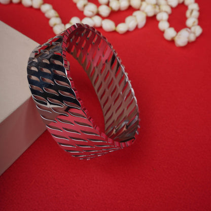 Wide, silver-tone open bracelet with an abstract geometric textured pattern ground image - Revaaj
