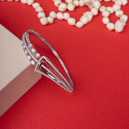 Silver-tone hinged bracelet with a sparkling geometric design, featuring pave crystals and marquise-cut crystal accents white background - Revaaj