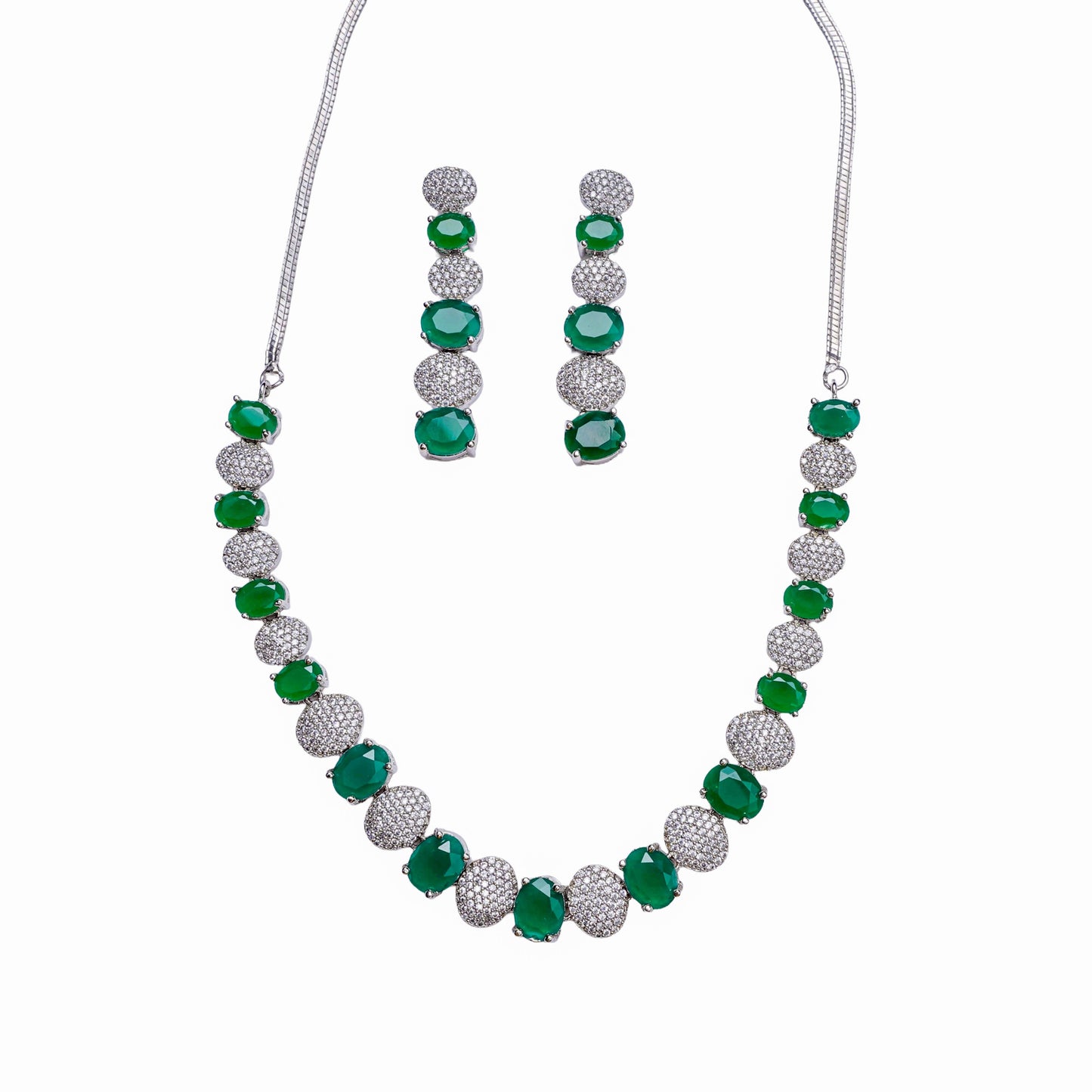 Necklace and earring set with alternating green stones and clear crystal-studded round links on white background