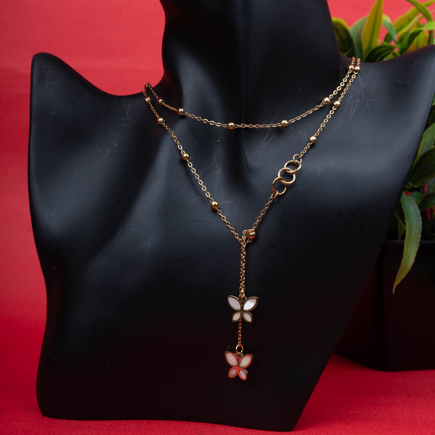 Gold-tone double layer necklace with white and pink butterfly pendants - Revaaj