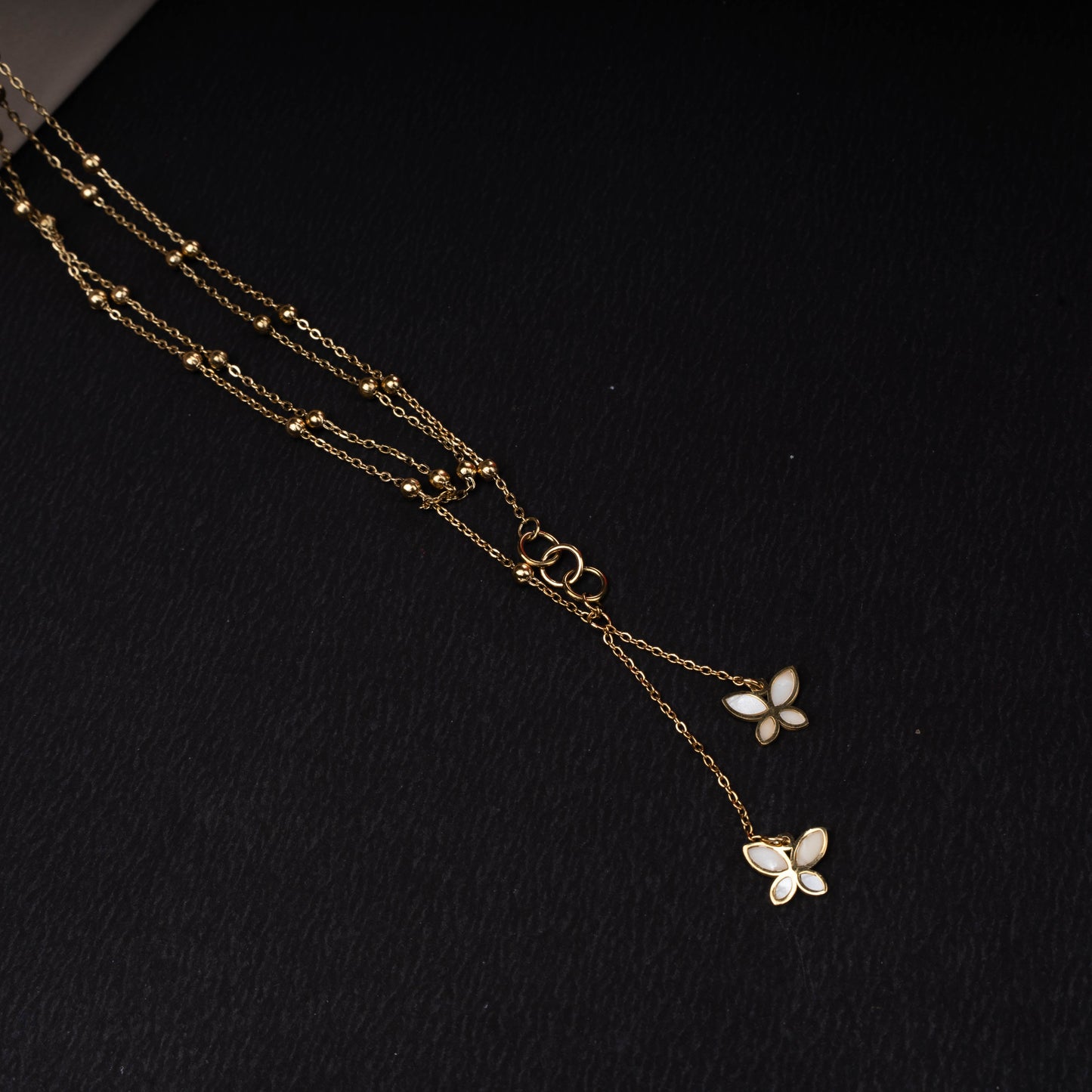 Gold-tone double layer necklace with white and pink butterfly pendants second view - Revaaj