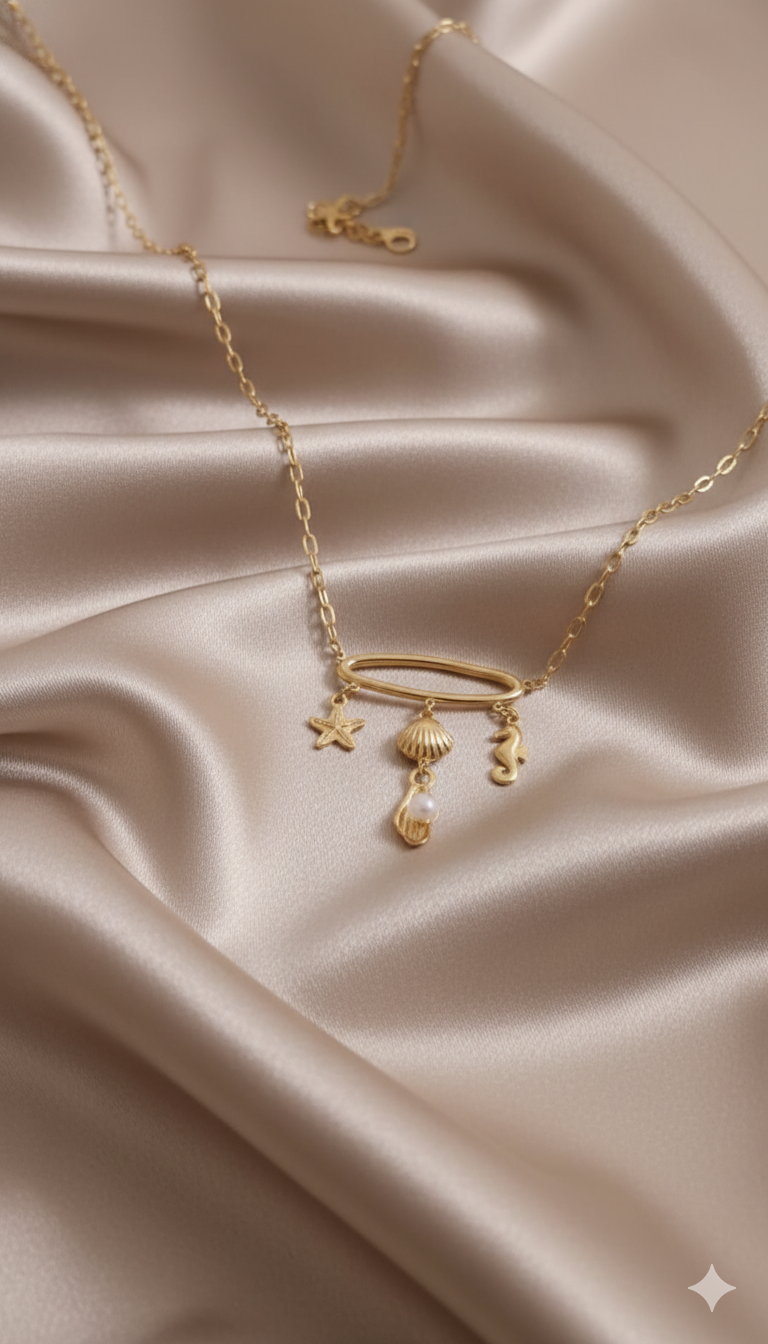 Gold-Plated Sea Charm Necklace with Starfish, Shell, Seahorse, and Pearl Drop stand