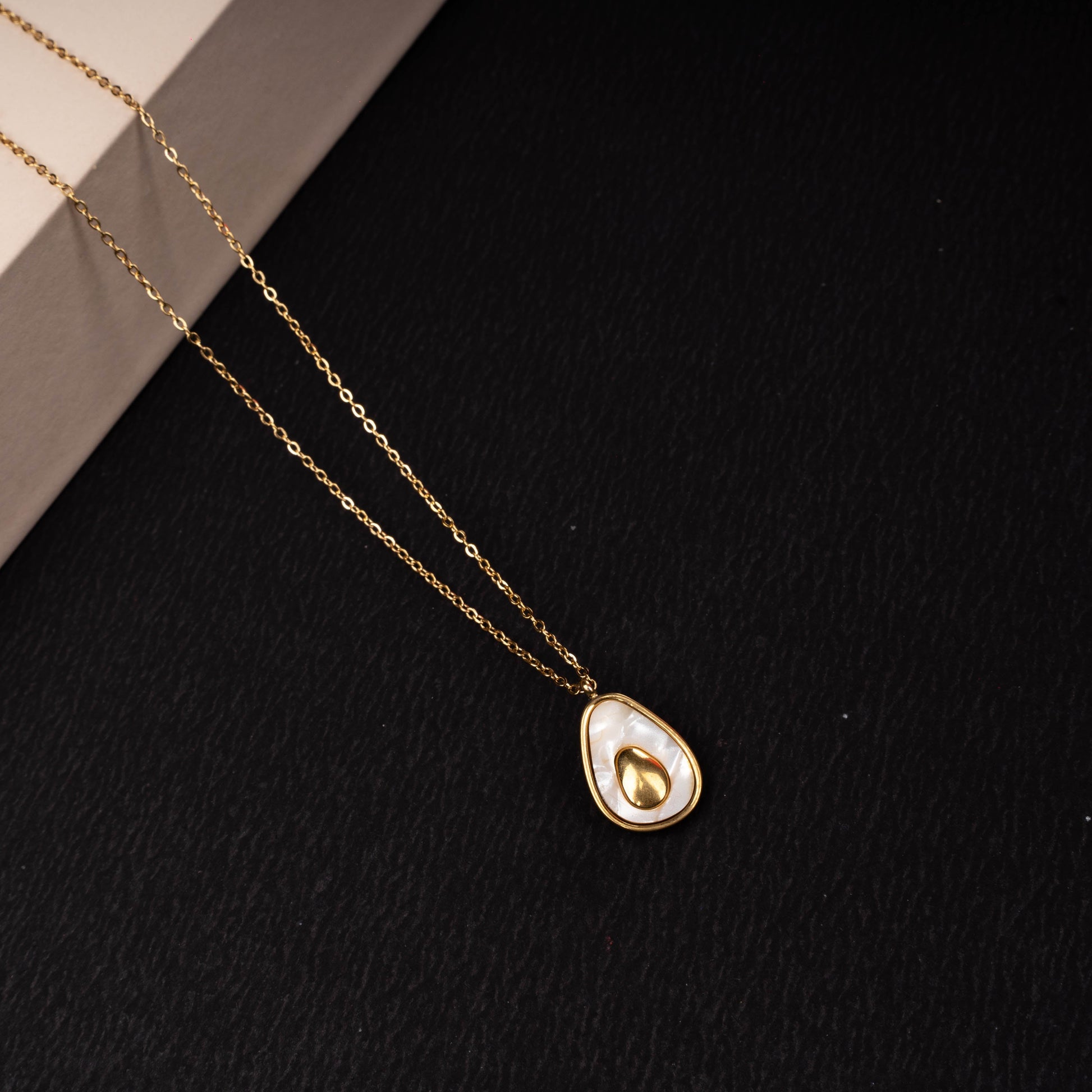 Gold-tone teardrop pendant necklace with polished accent second view - Revaaj