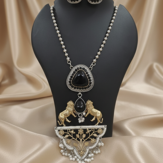 Royal black stone necklace set with golden lion motifs and pearl accents displayed on a black stand