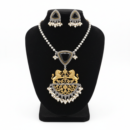 Royal black stone necklace set with golden lion motifs and pearl accents displayed on a black stand white