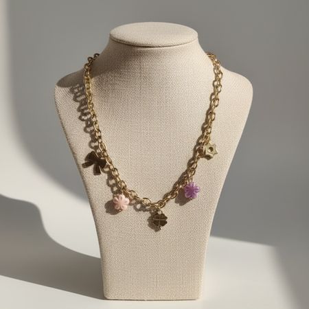 Gold-Plated Charm Necklace with Bow, Star, and Floral Pendants and Pink-Purple Bead Accents