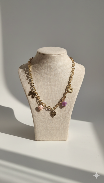 Gold-Plated Charm Necklace with Bow, Star, and Floral Pendants and Pink-Purple Bead Accents